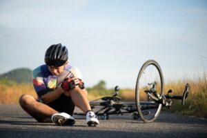 cyclist on road after falling off bike