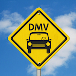 Yellow sign that says "DMV" with a graphic of a vehicle, against a blue cloudy sky