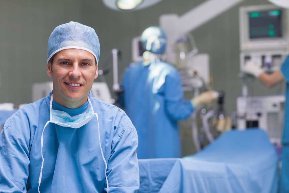 A doctor in scrubs in a surgery room.