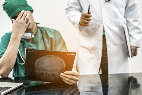 doctor looking at x-ray - our Las Vegas medical malpractice attorneys help victims to bring legal claims