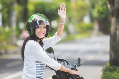 Biker wearing helmet and waving - Nevada motorcycle laws require riders to wear helmets