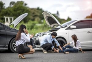 Aftermath of head-on crash where three drivers and passengers administer first-aid and call the police