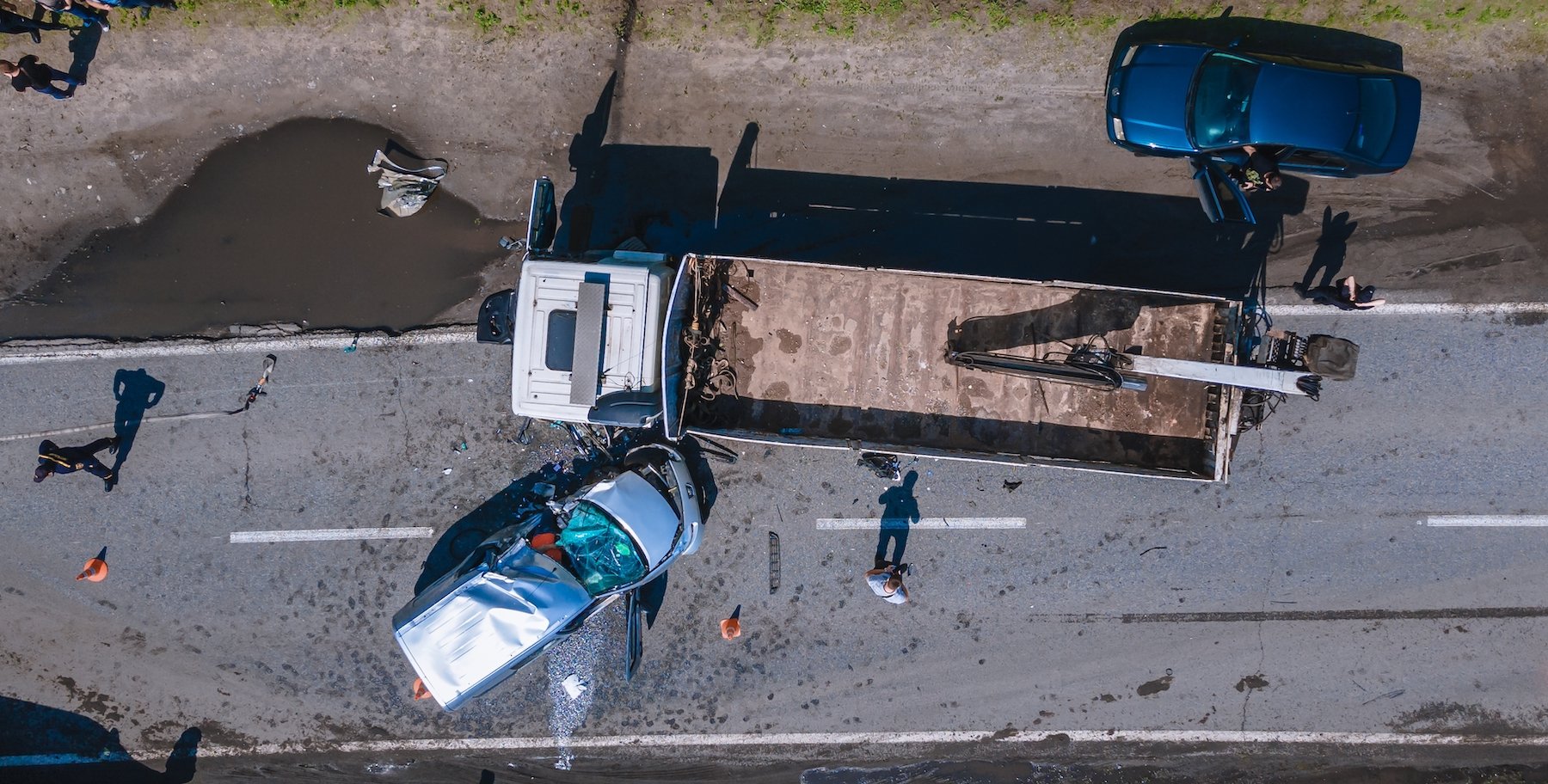Overhead view of aftermath of trucking accident with two sedans