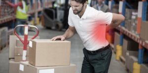 Warehouse worker grabbing back in pain