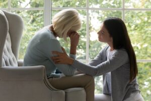 Young woman comforting new widow