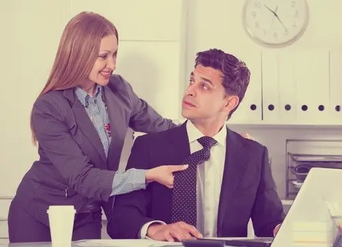 woman sexually harassing man in workplace