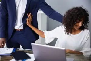 Woman pushing male co-worker away